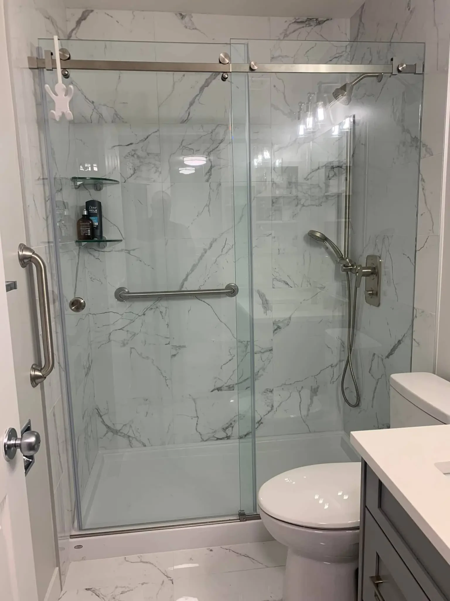 Completed bathroom renovation with modern tile and walk-in shower in a Calgary home by Advanced Renovations