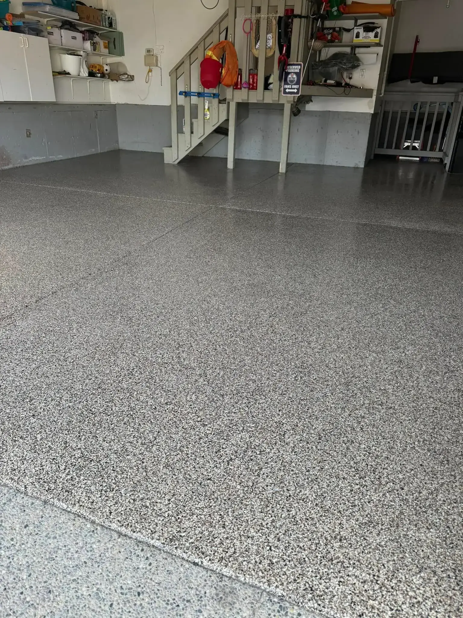 Professional epoxy floor coating installation with decorative finish in Calgary garage